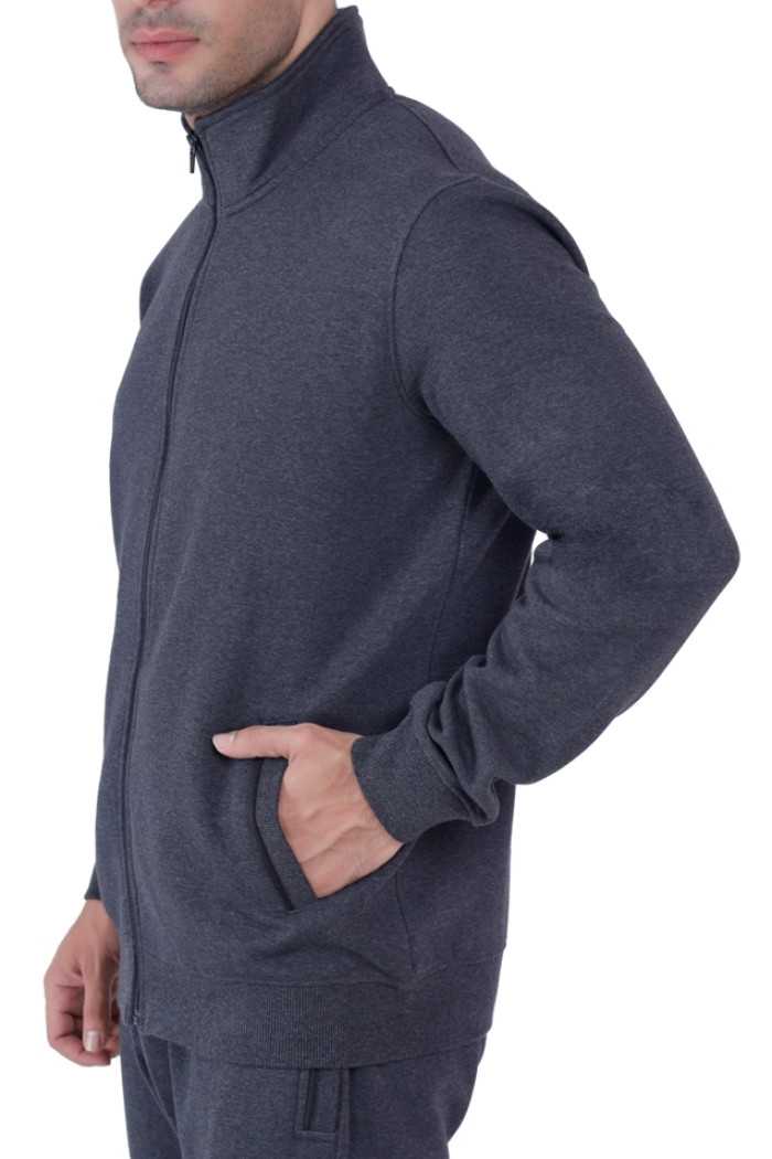 lose-up side view of a man wearing Coatsnmore’s Super Anthra zip-up tracksuit jacket with a high collar, hand placed in the front pocket, showing the fit and fabric texture.